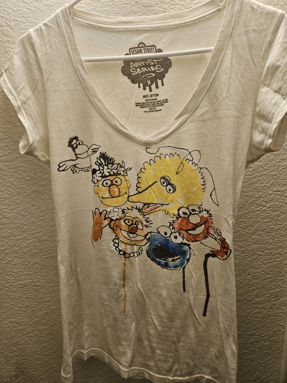 Sesame Street White V-Neck Tee with Yellow, Blue, Orange Character Art